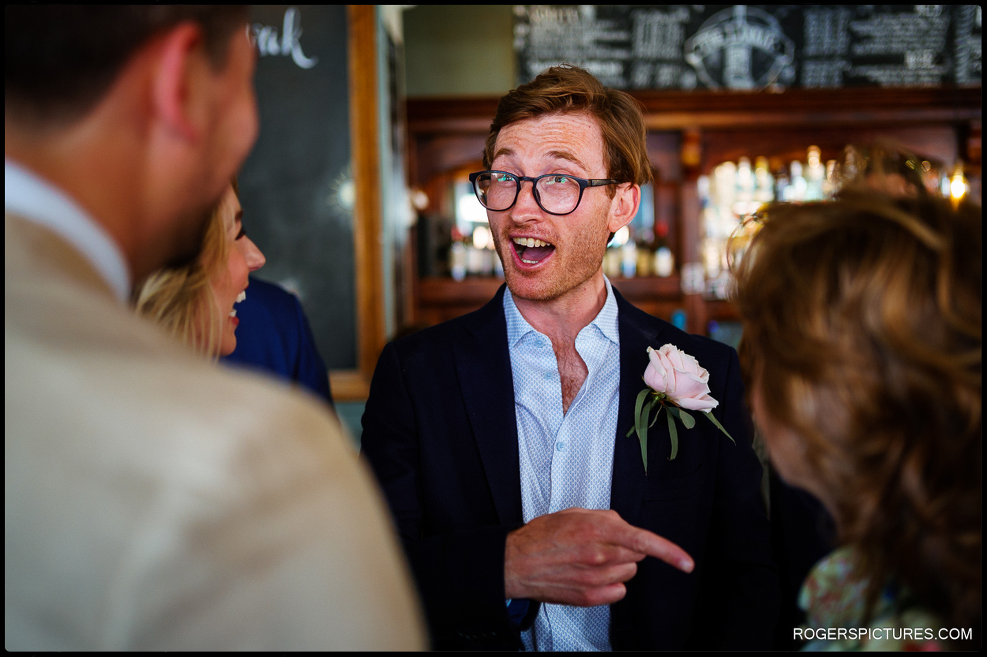 Guest laughing and chatting during pre-wedding drinks at The Larrick in London.