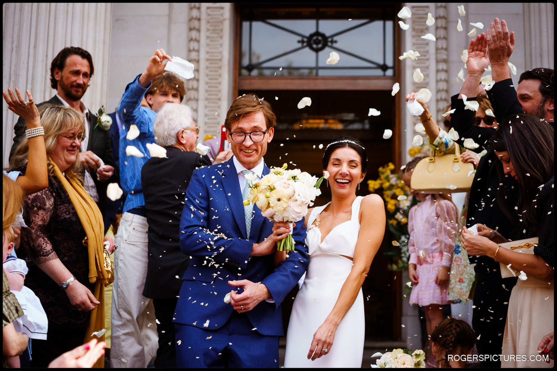 Confetti shower outside Marylebone Town Hall as the bride and groom celebrate with guests.