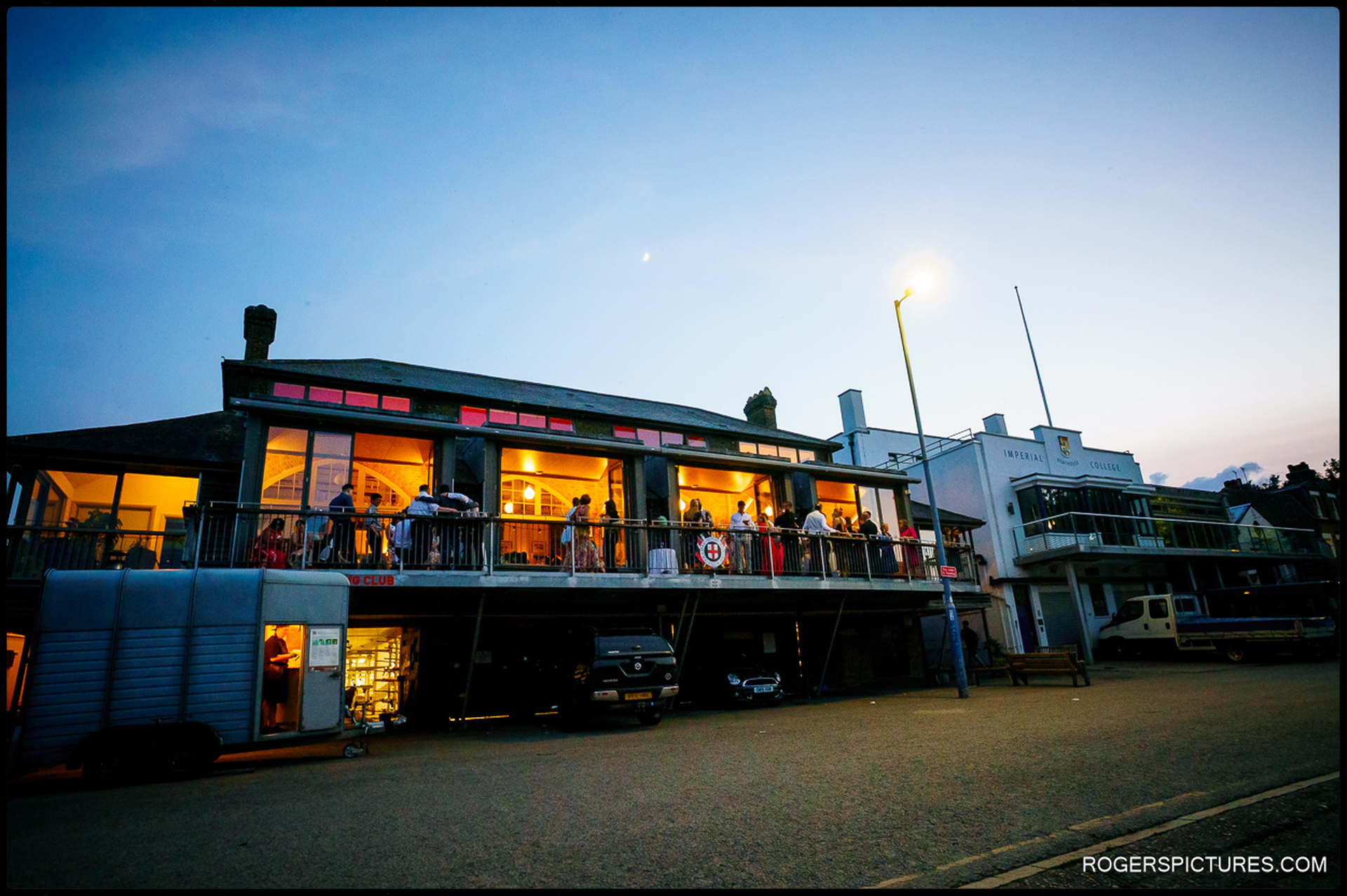 Exterior view of Thames Rowing Club lit up during the evening wedding reception
