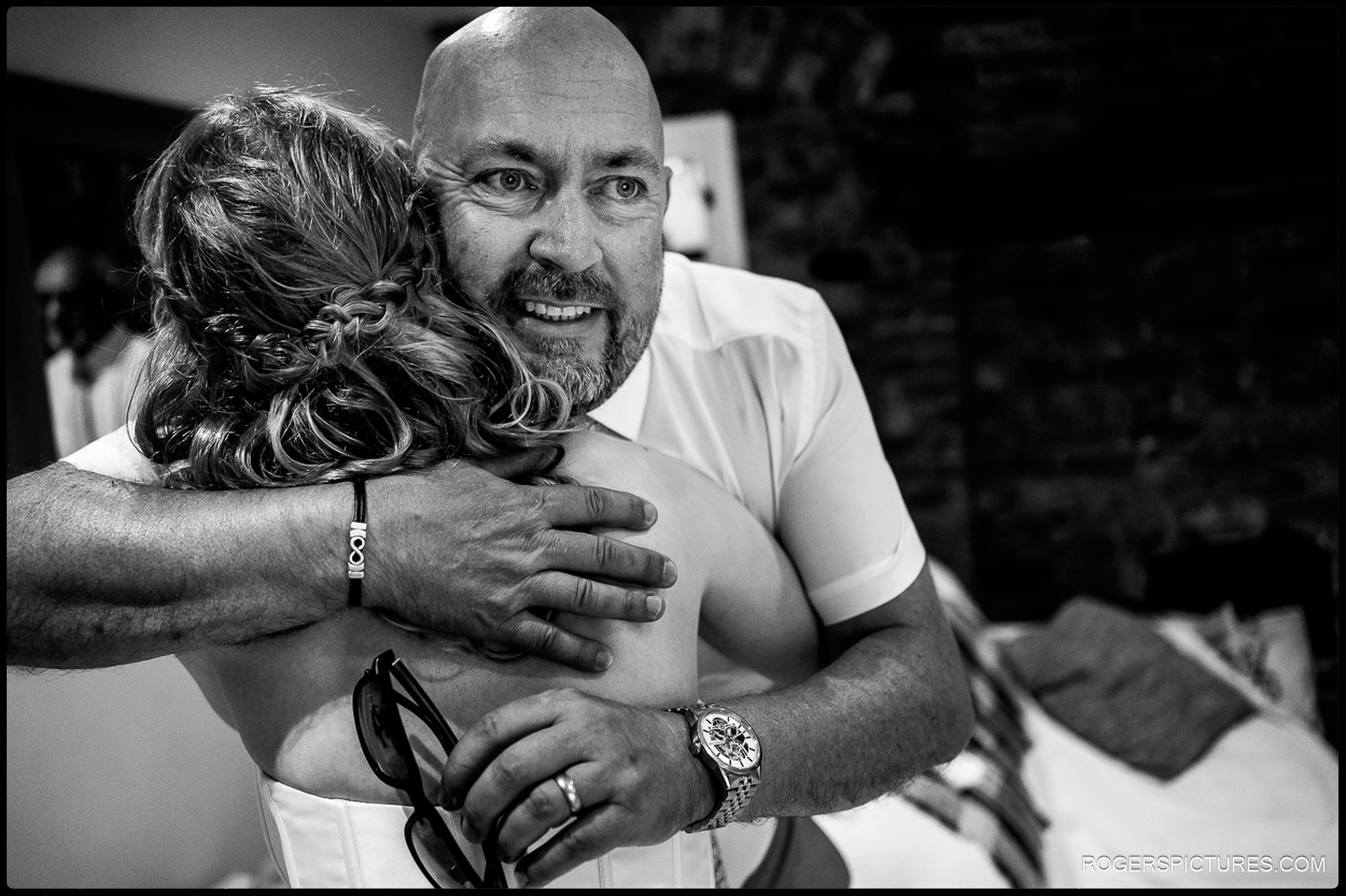Father of the bride hugging his daughter just moments before they leave for the church.