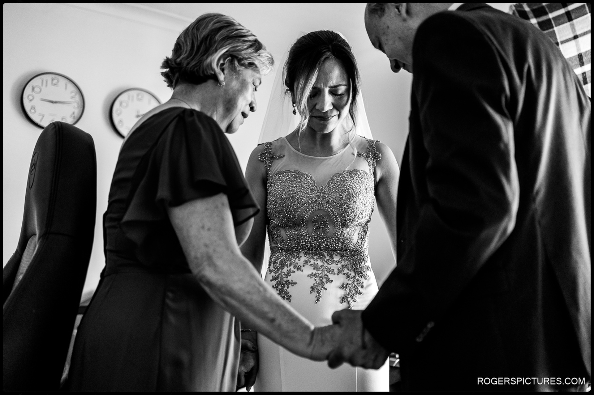 Bride prays with Mother and Father before wedding ceremony