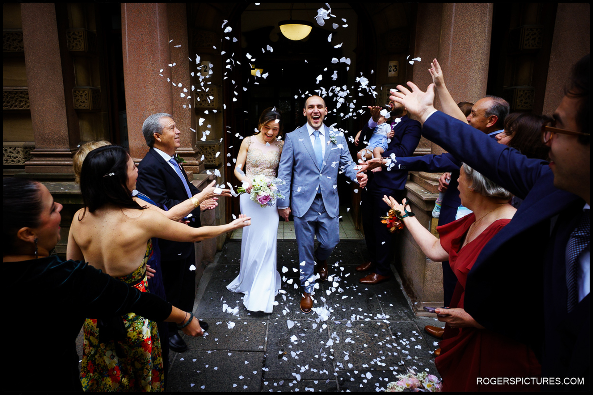 Confetti and newly wed couple outside City Chambers in Glasgow