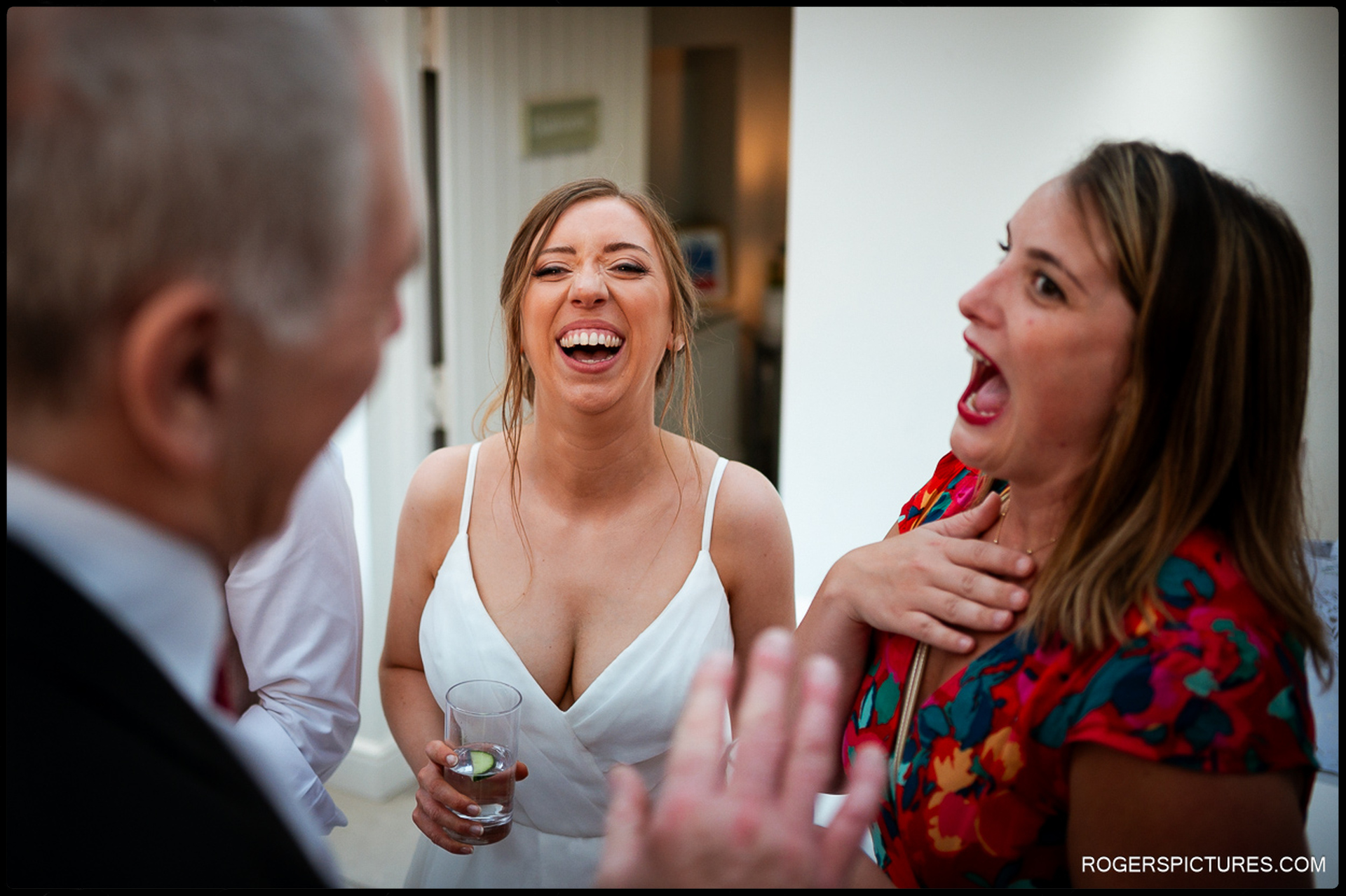 Bride laughing with guests during the evening reception.