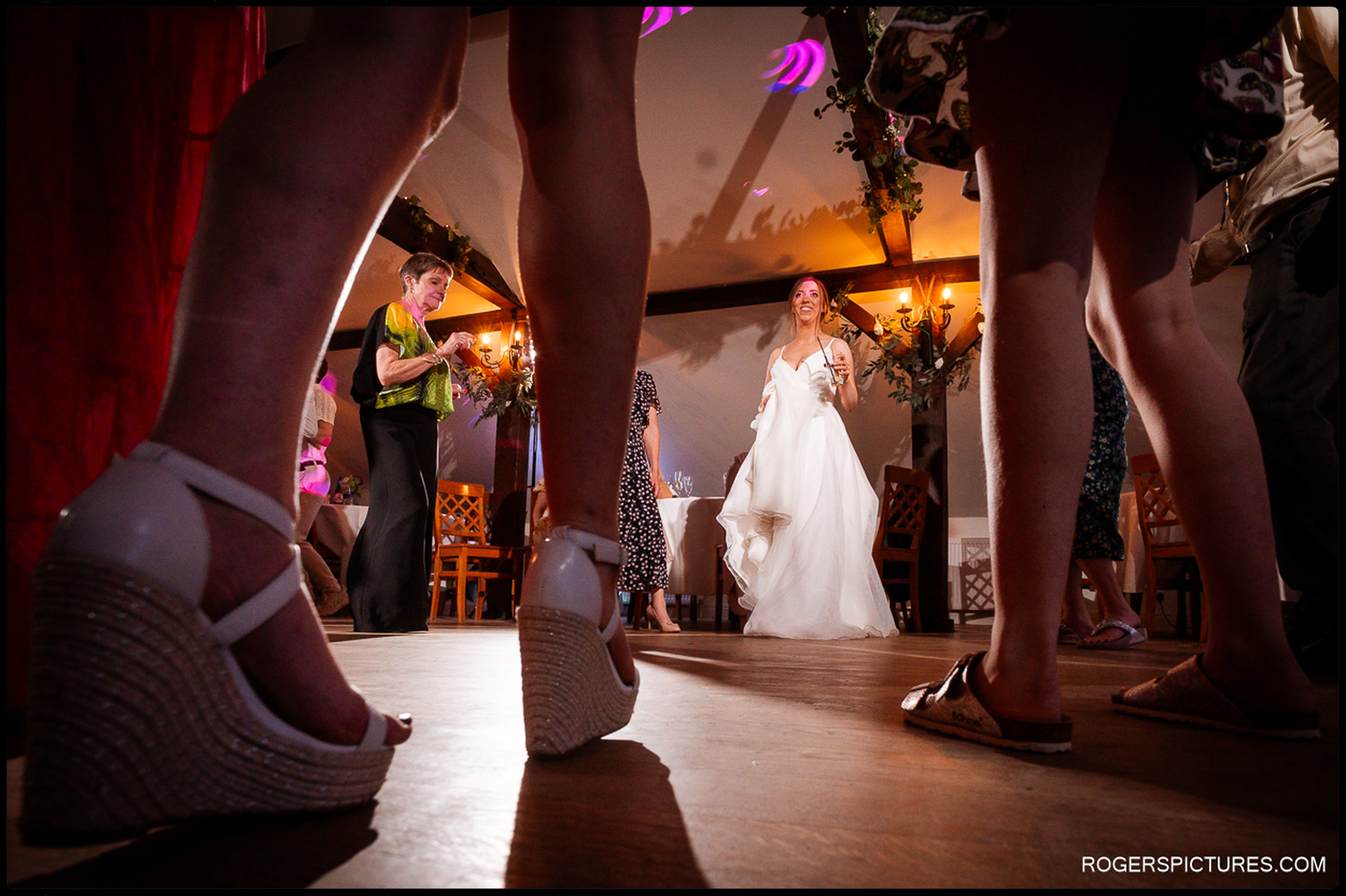 Bride and groom laughing and dancing together during the evening reception