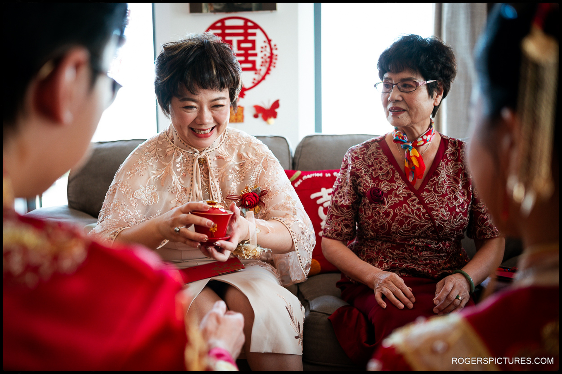 Family member smiling while accepting tea during the Chinese tea ceremony