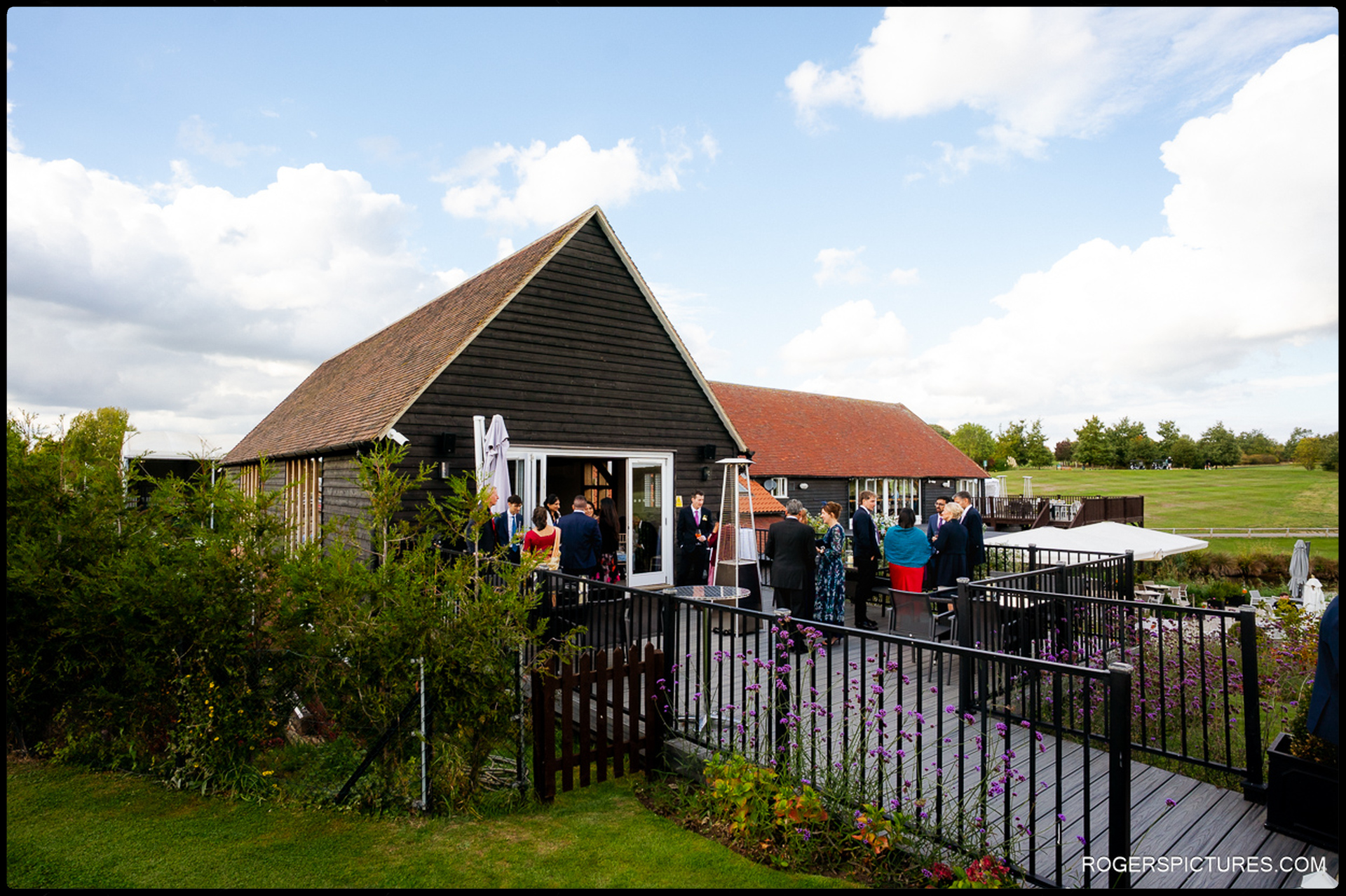 Guests gather on the terrace at Heron Country Club during the afternoon reception.