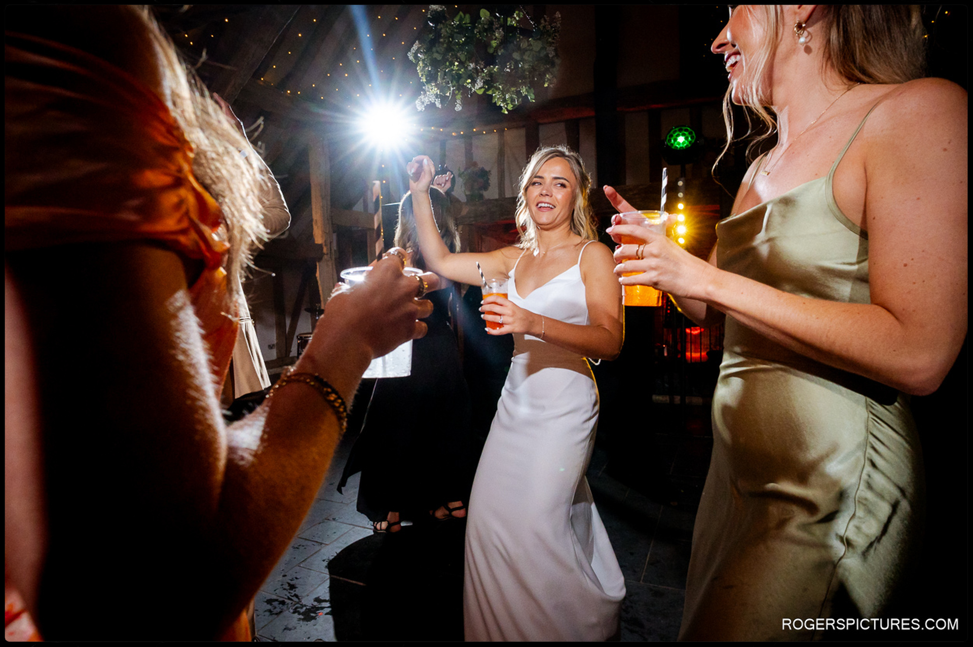 Bride dancing with bridesmaids during the evening party at Rumbolds Farm.