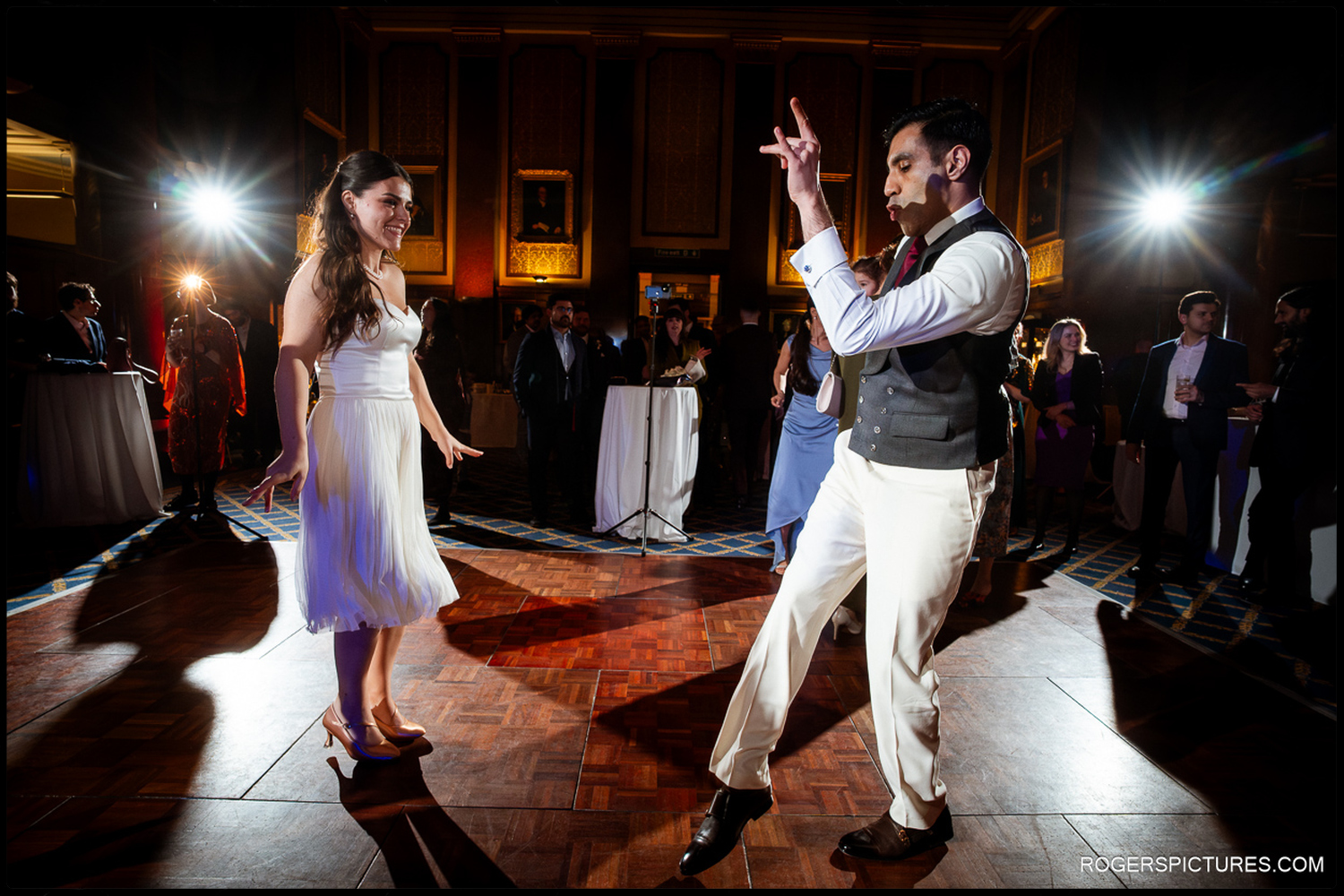 A lively candid shot of the groom dancing and gesturing with his hands during the evening party at 113 Chancery Lane.